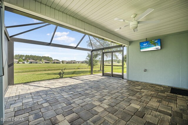 view of patio with a lanai, ceiling fan, a hot tub, and an outdoor hangout area