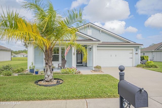 view of front of home with a garage and a front lawn