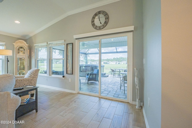 entryway with light hardwood / wood-style flooring, lofted ceiling, and ornamental molding