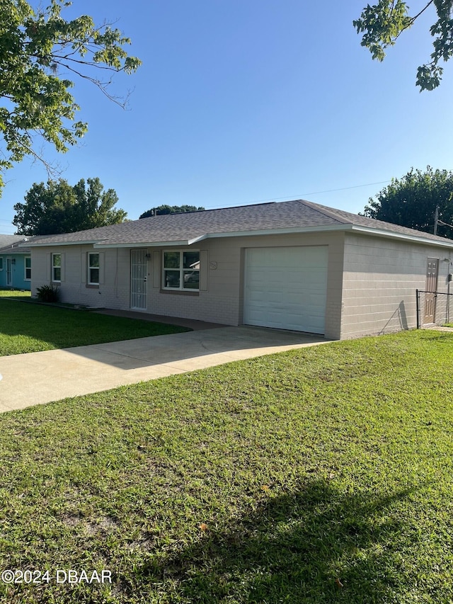 single story home with a front lawn and a garage