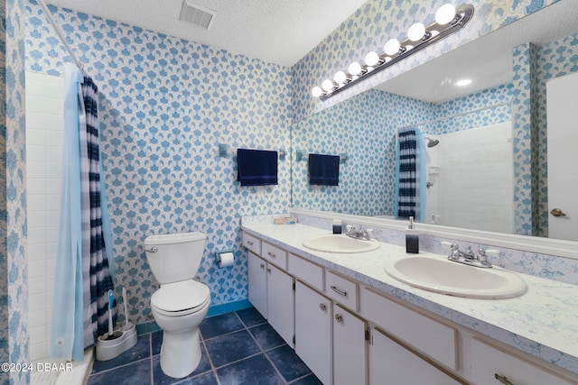 bathroom with toilet, curtained shower, tile patterned flooring, a textured ceiling, and vanity