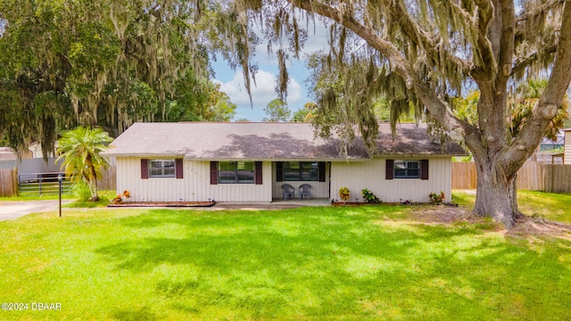 ranch-style house with a front lawn