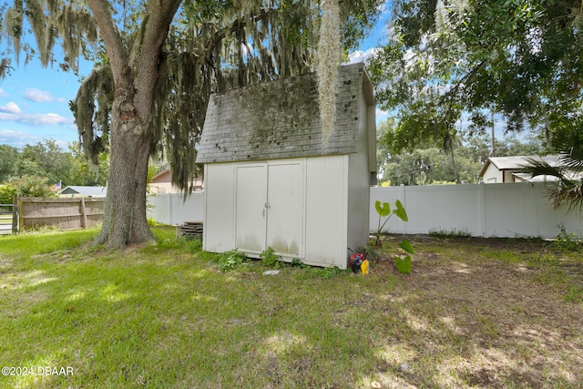 view of outbuilding featuring a lawn