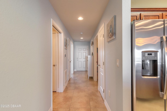 corridor with light tile patterned floors, visible vents, baseboards, and recessed lighting