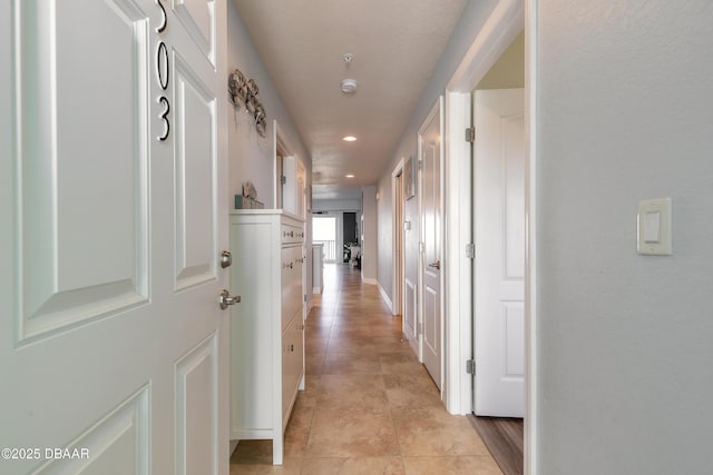 hallway featuring light tile patterned floors and recessed lighting