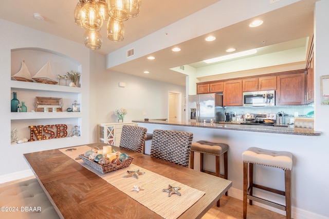 dining room featuring built in features and a chandelier