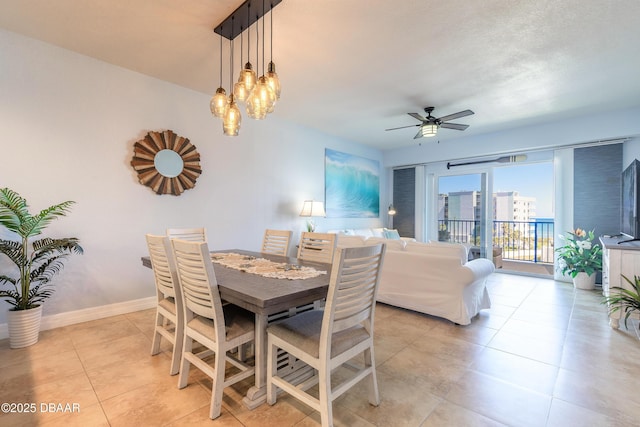 dining room featuring light tile patterned floors, a ceiling fan, and baseboards