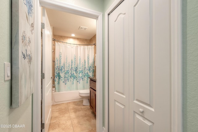 full bath with vanity, shower / bathtub combination with curtain, visible vents, tile patterned floors, and toilet