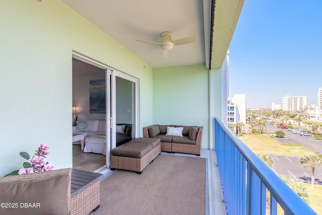 balcony featuring a view of city and a ceiling fan