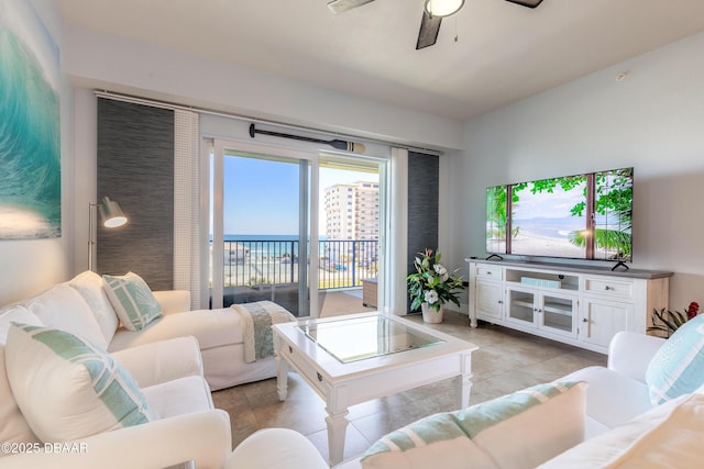 living area featuring light tile patterned floors and a ceiling fan