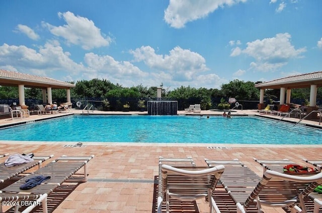 pool with a gazebo and a patio area