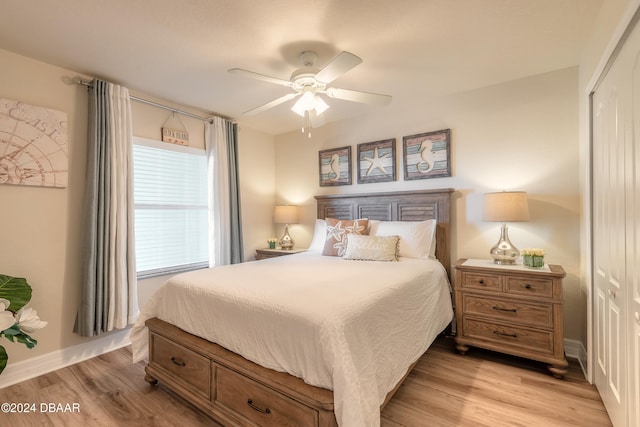 bedroom featuring light wood-type flooring, ceiling fan, and a closet