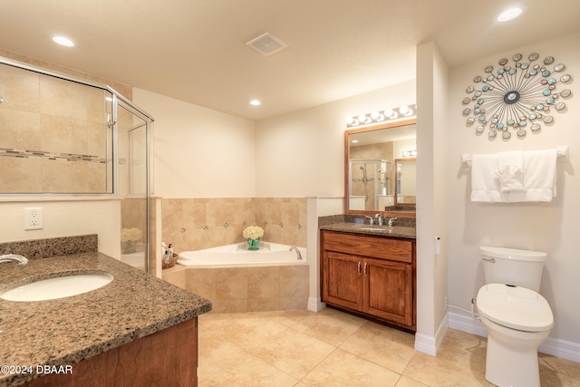 full bathroom featuring toilet, vanity, tile patterned floors, and separate shower and tub