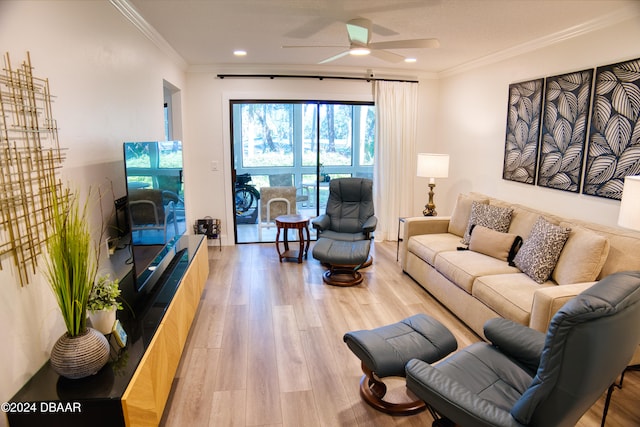 living room with ceiling fan, ornamental molding, and light wood-type flooring