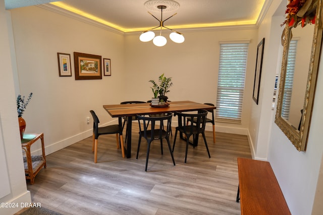 dining space featuring crown molding and light wood-type flooring