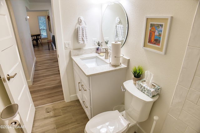 bathroom featuring hardwood / wood-style flooring, vanity, and toilet