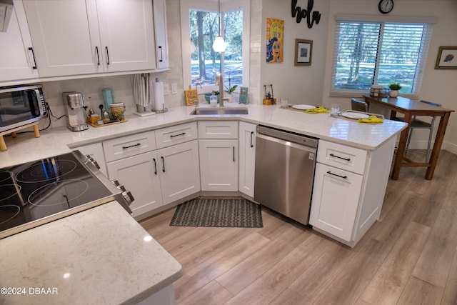 kitchen featuring white cabinetry, a healthy amount of sunlight, stainless steel appliances, and light hardwood / wood-style floors