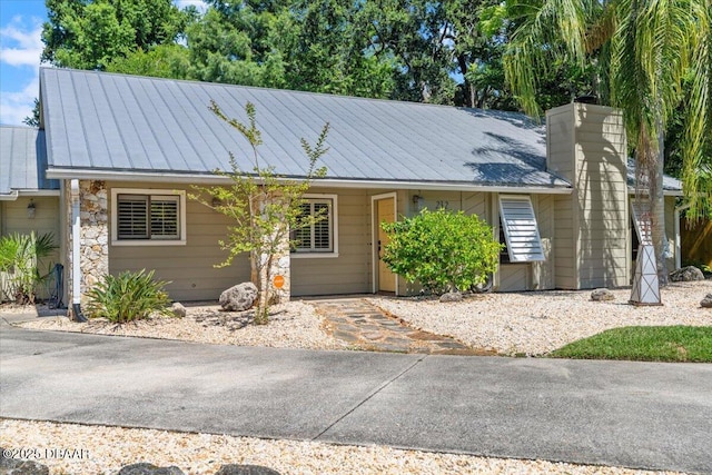 232 Chippewa Cir, Ormond Beach, FL 32174 - ranch-style house with a metal roof and a chimney