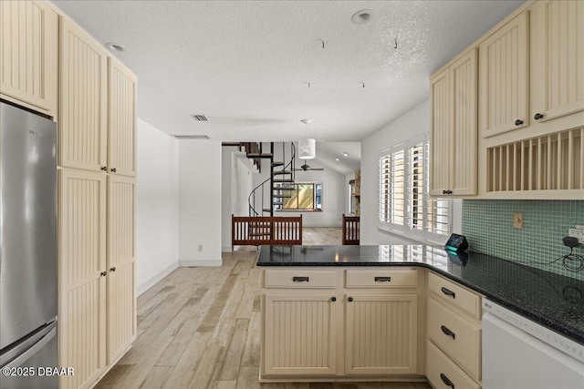 232 Chippewa Cir, Ormond Beach, FL 32174 - kitchen featuring cream cabinetry, freestanding refrigerator, white dishwasher, a peninsula, and light wood-style floors