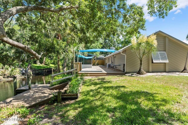 232 Chippewa Cir, Ormond Beach, FL 32174 - view of grassy yard with a dock and a deck with water view