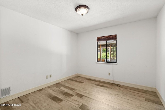 232 Chippewa Cir, Ormond Beach, FL 32174 - spare room featuring wood finished floors and a textured ceiling