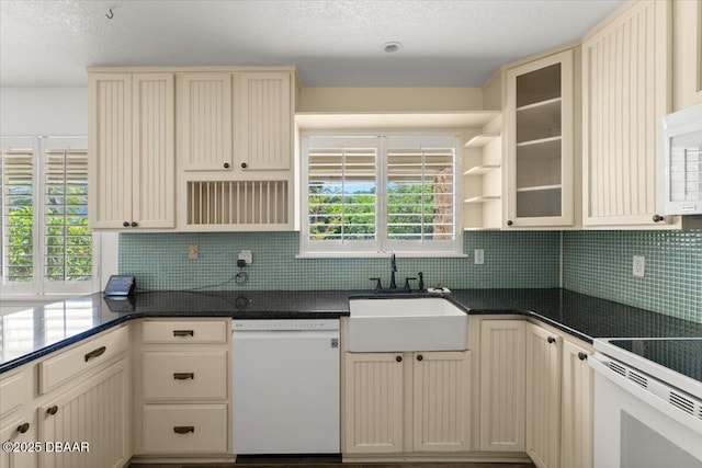 232 Chippewa Cir, Ormond Beach, FL 32174 - kitchen with white appliances, open shelves, cream cabinetry, decorative backsplash, and a textured ceiling
