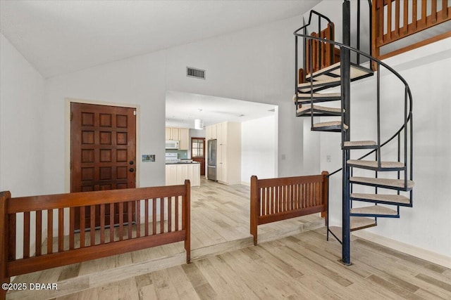 232 Chippewa Cir, Ormond Beach, FL 32174 - staircase featuring wood finished floors and high vaulted ceiling