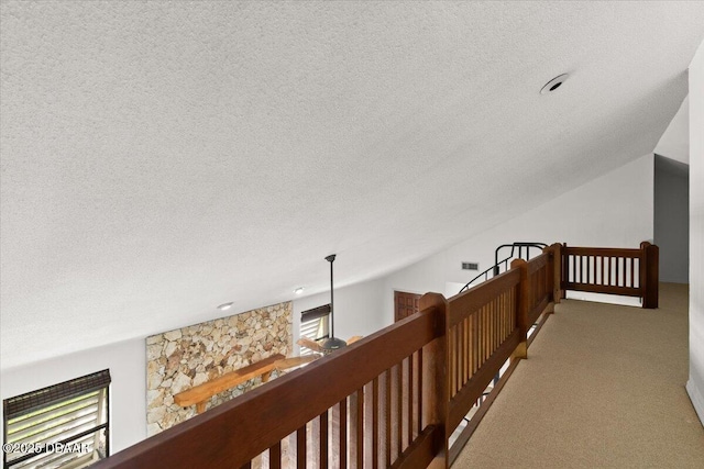 232 Chippewa Cir, Ormond Beach, FL 32174 - hallway with an upstairs landing, a textured ceiling, and carpet flooring