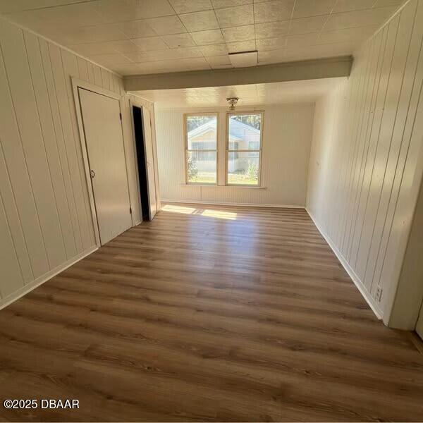 unfurnished room with dark wood-type flooring