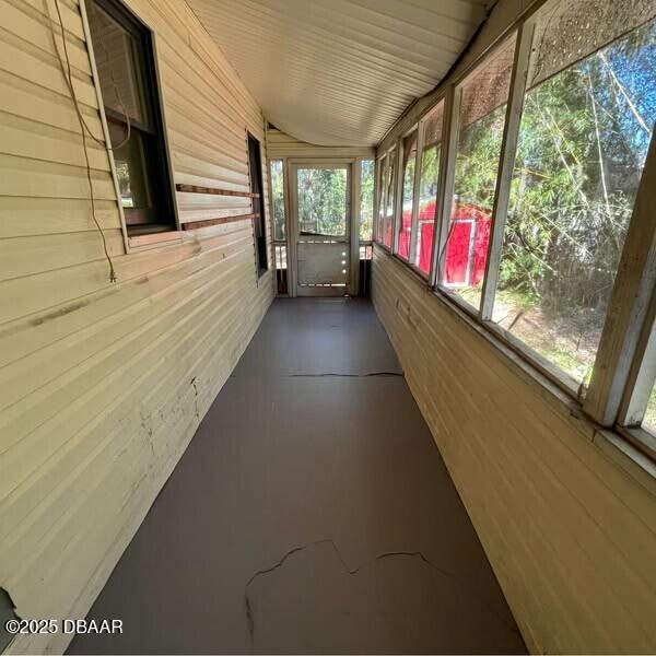 unfurnished sunroom featuring a healthy amount of sunlight