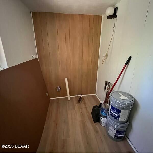 clothes washing area with hardwood / wood-style floors