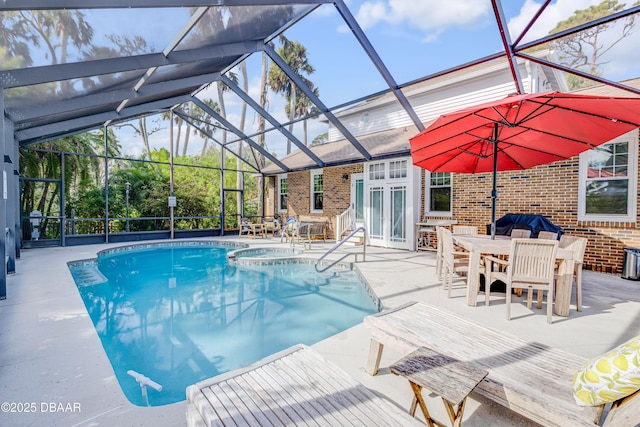 view of swimming pool with a pool with connected hot tub, french doors, glass enclosure, and a patio