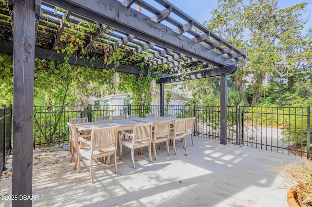 view of patio featuring outdoor dining area, fence, and a pergola