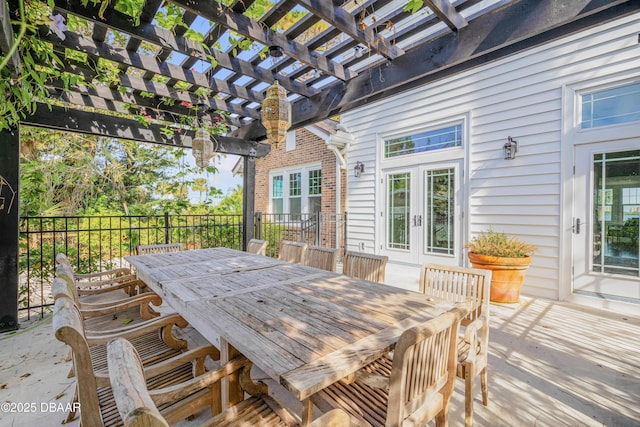 wooden terrace with outdoor dining space, french doors, fence, and a pergola