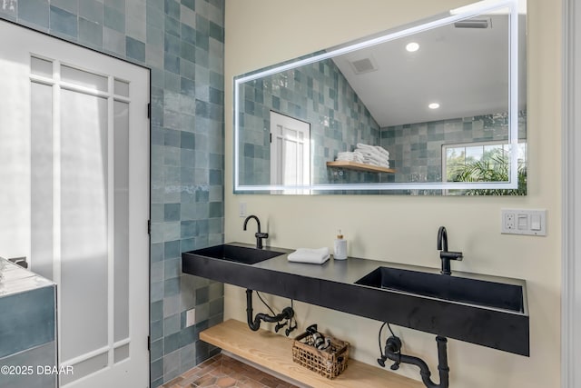 full bath with recessed lighting, visible vents, and tile walls