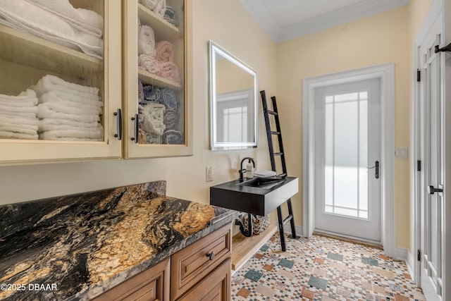 entryway with baseboards and crown molding