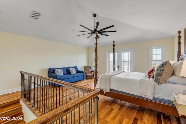 bedroom with light wood-style flooring, visible vents, a ceiling fan, vaulted ceiling, and access to outside