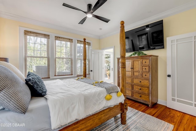 bedroom featuring ornamental molding, wood finished floors, and a ceiling fan