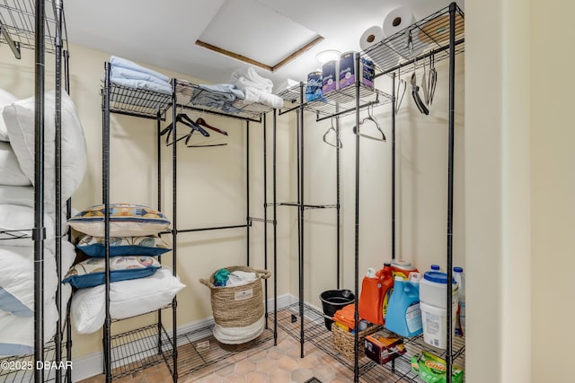 walk in closet featuring attic access