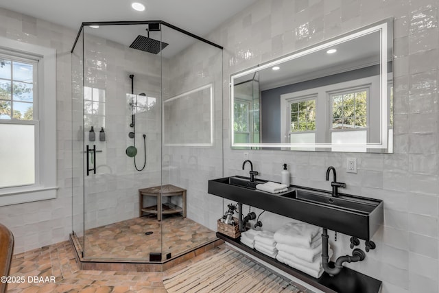 full bath with a stall shower, tile walls, and recessed lighting