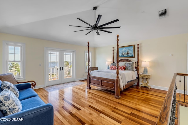 bedroom with lofted ceiling, access to outside, multiple windows, and french doors