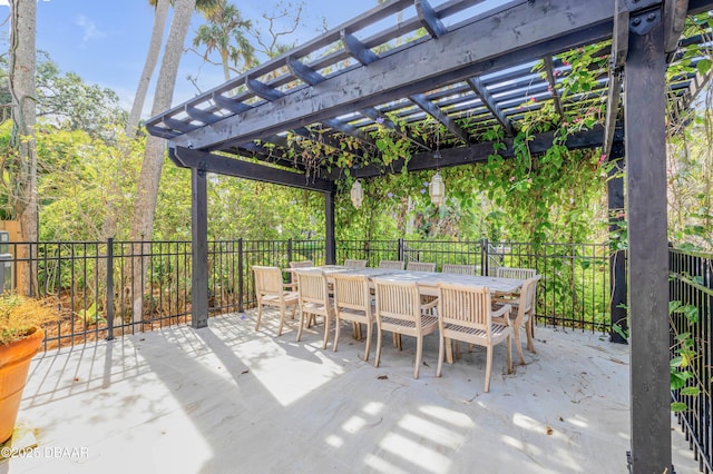 view of patio with outdoor dining area, fence, and a pergola