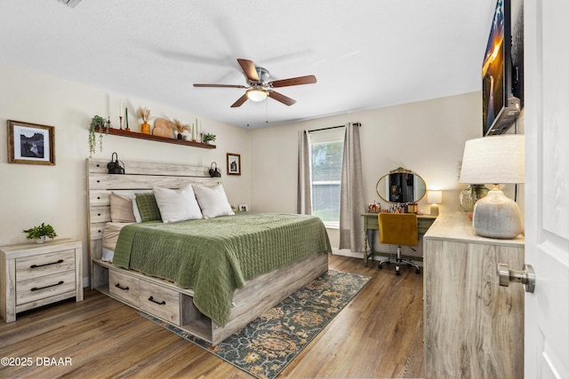 bedroom featuring ceiling fan, dark wood-type flooring, and baseboards