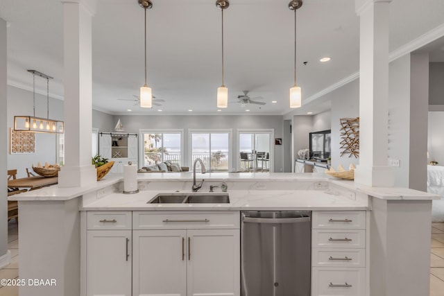 kitchen with ornate columns, pendant lighting, dishwasher, sink, and white cabinets