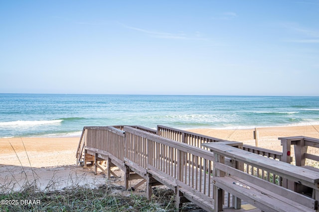 surrounding community with a beach view and a water view