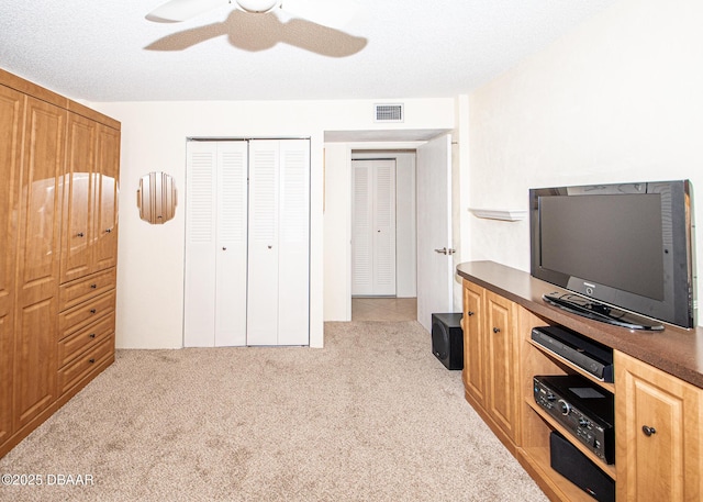 office space featuring light colored carpet and ceiling fan