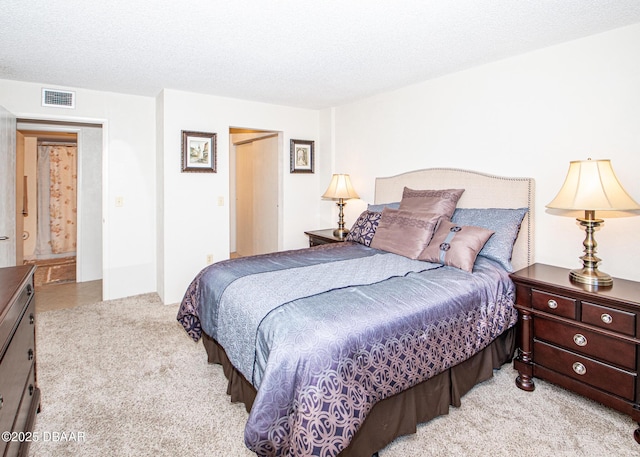 carpeted bedroom with a textured ceiling