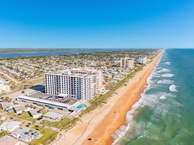 drone / aerial view featuring a beach view and a water view