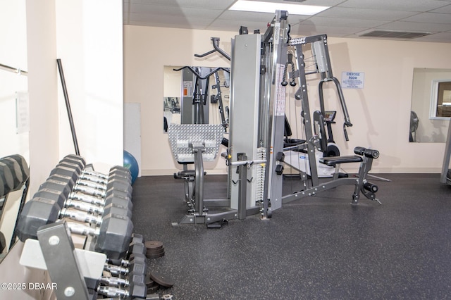 exercise room featuring a paneled ceiling