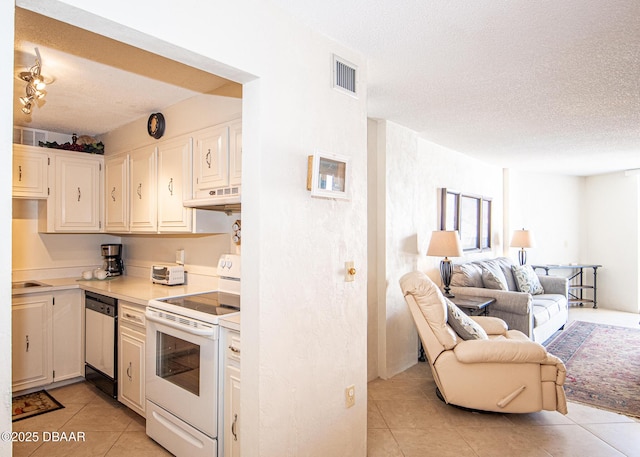 kitchen with electric stove, light tile patterned floors, a textured ceiling, and dishwasher